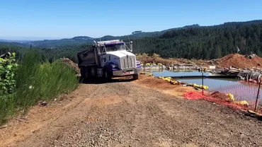 Dump truck hauling material at a lagoon cleanout